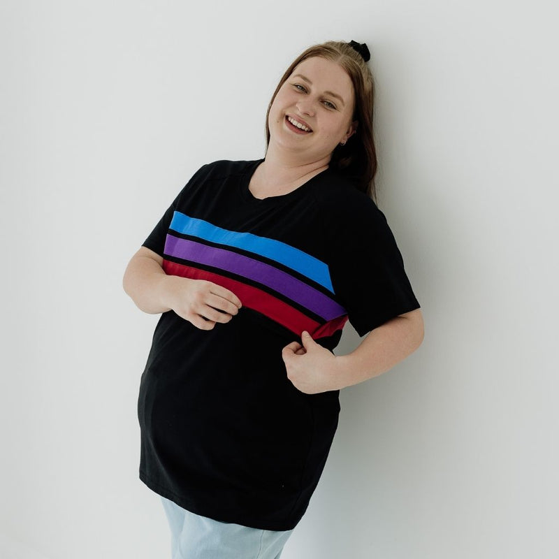 A size XL mum wearing a black nursing tee that features stripes in blue, purple and red.