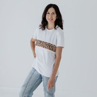 A size 8 mum showing the length of a white breastfeeding t-shirt with a leopard print panel.