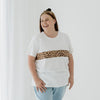 A size XL mum wears a white t-shirt featuring a leopard print panel that hides an invisible zip for feeding access.