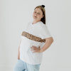 A size 16 mum modelling a white nursing tee that features a two-way zip that is invisible under a leopard print panel.