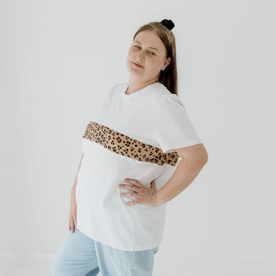 A size 16 mum modelling a white nursing tee that features a two-way zip that is invisible under a leopard print panel.