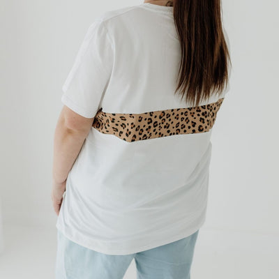 The back of a white t-shirt that features a leopard print panel.