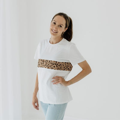 A size 8 mum wearing a white leopard print feeding friendly t-shirt.