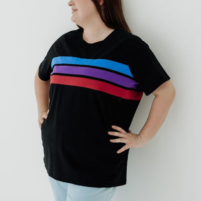 A size 16 mum wearing a black breastfeeding t-shirt that has coloured stripes to hide a horizontal zip.
