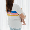 A size XL mum breastfeeding her baby in a white t-shirt with stripes of blue, pink and yellow.