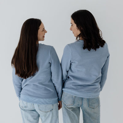 Two mums showing the different fit of a steel blue jumper.